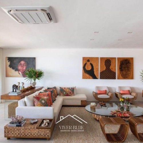 Sala de estar integrada com decoração contemporânea, móveis de design e ambiente amplo e iluminado.